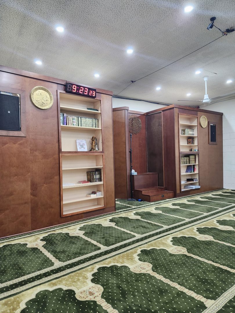 Seminary mihrab and library shelves in the prayer hall